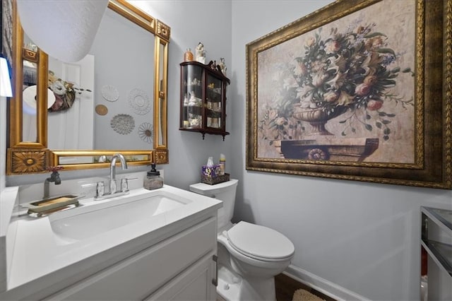 bathroom featuring vanity and toilet