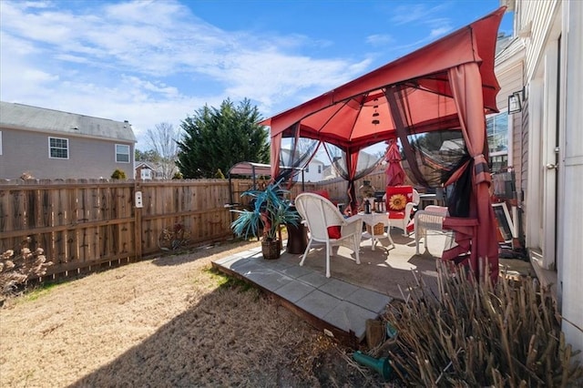 view of playground featuring a fenced backyard, a patio, and a gazebo