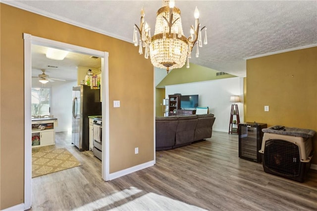 kitchen featuring hardwood / wood-style floors, stainless steel appliances, wine cooler, ornamental molding, and a textured ceiling