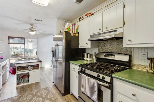 kitchen with white cabinets, decorative backsplash, ceiling fan, stainless steel appliances, and light hardwood / wood-style flooring