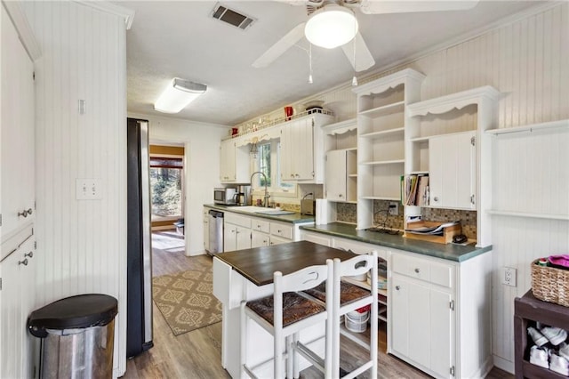 kitchen with sink, white cabinets, ceiling fan, stainless steel appliances, and light wood-type flooring