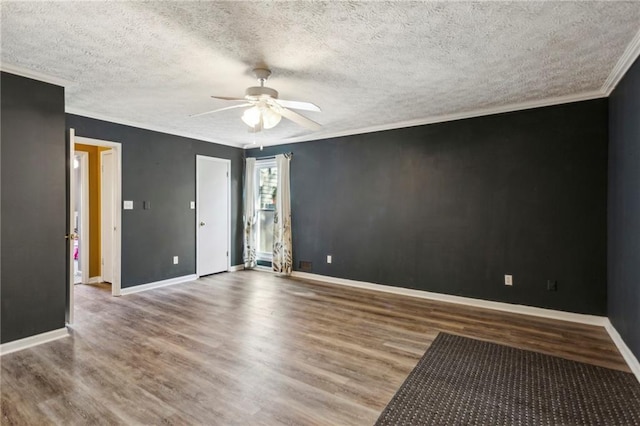 empty room with hardwood / wood-style flooring, ornamental molding, a textured ceiling, and ceiling fan