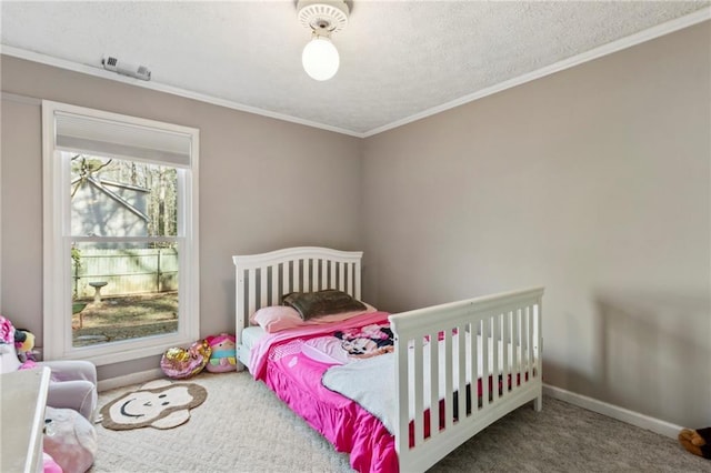 carpeted bedroom with ornamental molding and a textured ceiling