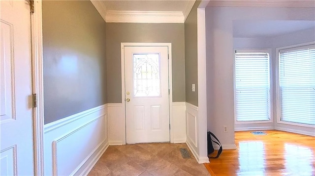 entryway featuring crown molding and light hardwood / wood-style floors