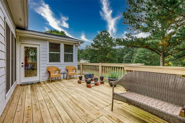 wooden terrace with an outdoor living space