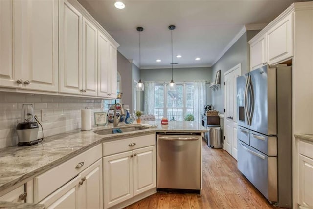 kitchen with sink, stainless steel appliances, light hardwood / wood-style floors, and white cabinets