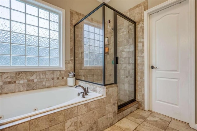 bathroom with tile floors, plenty of natural light, and plus walk in shower