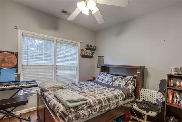 bedroom featuring ceiling fan and dark hardwood / wood-style floors