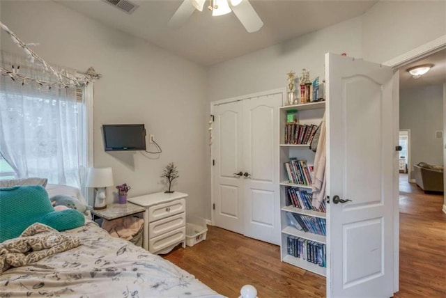 bedroom featuring ceiling fan, a closet, and hardwood / wood-style floors