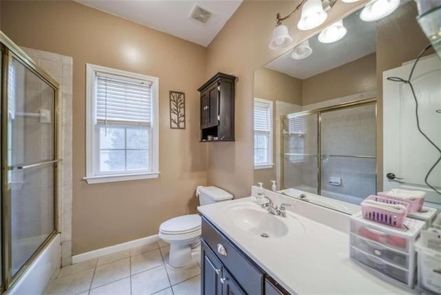 full bathroom featuring tile floors, toilet, oversized vanity, and a healthy amount of sunlight