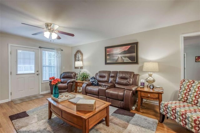 living room with ceiling fan and light wood-type flooring