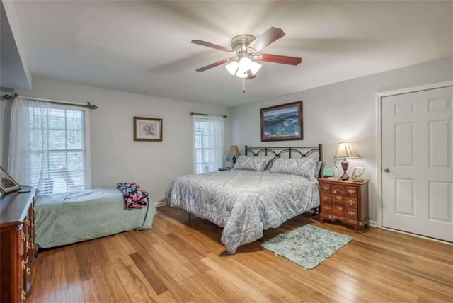 bedroom with ceiling fan and light hardwood / wood-style flooring