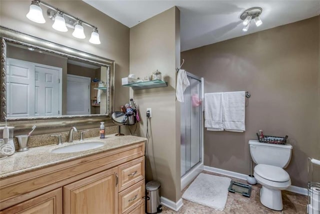 bathroom with toilet, a shower with door, tile floors, and large vanity