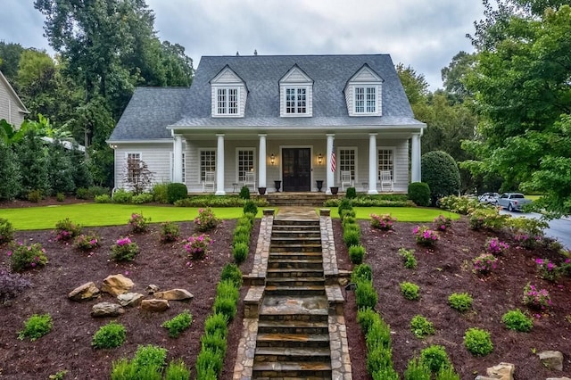 cape cod-style house with a porch and a front yard