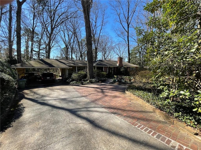 ranch-style home featuring a carport