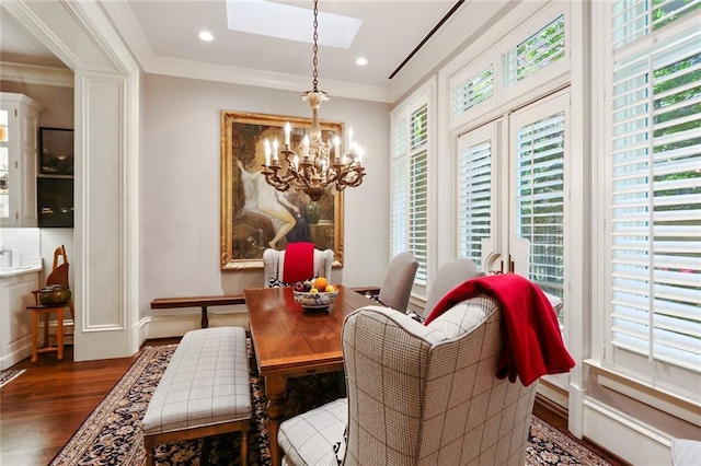 dining area with a chandelier, plenty of natural light, a skylight, and dark wood-type flooring