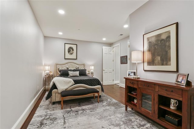 bedroom with dark wood-type flooring