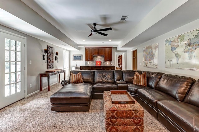 living room with ceiling fan and carpet flooring