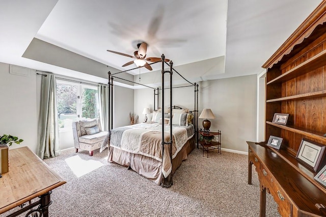 carpeted bedroom featuring ceiling fan with notable chandelier