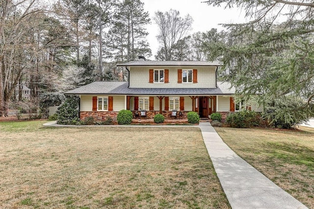 view of front of house with a porch and a front lawn