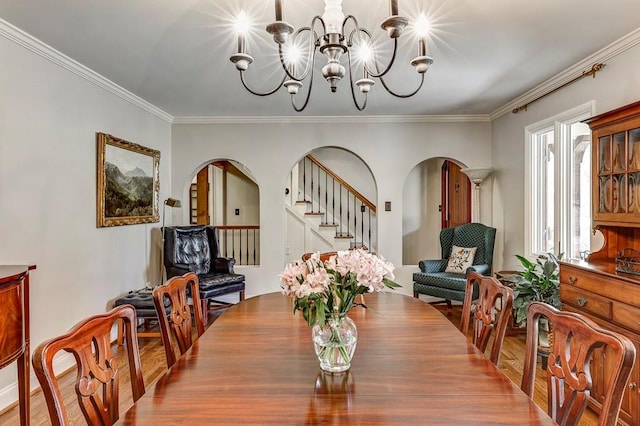 dining room featuring a chandelier, hardwood / wood-style floors, and crown molding