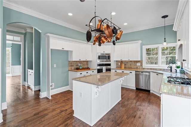 kitchen featuring tasteful backsplash, dark wood-type flooring, appliances with stainless steel finishes, and white cabinetry