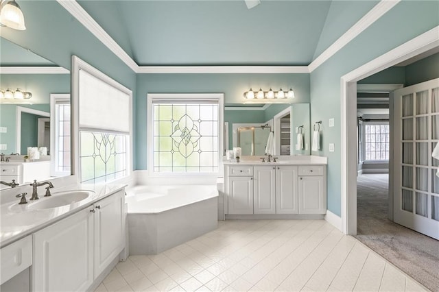 bathroom with tile floors, oversized vanity, a bathing tub, and lofted ceiling