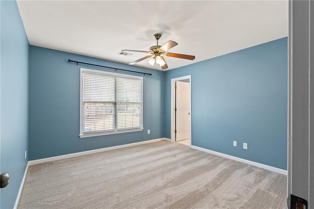 carpeted spare room featuring ceiling fan