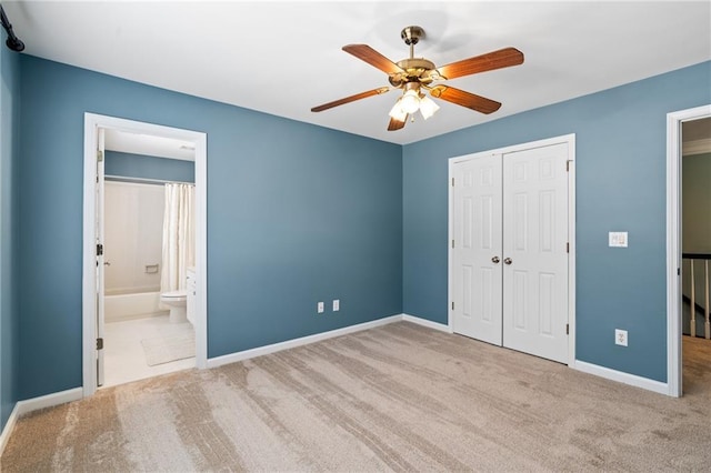 unfurnished bedroom with ceiling fan, connected bathroom, light tile flooring, and a closet