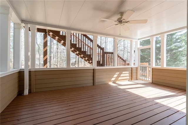 unfurnished sunroom featuring ceiling fan