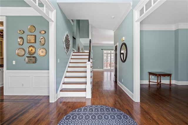 staircase with ornamental molding and dark wood-type flooring