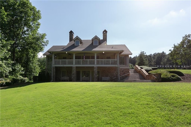 back of house featuring ceiling fan and a yard