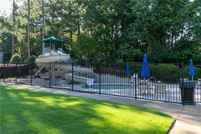 view of sport court with a yard