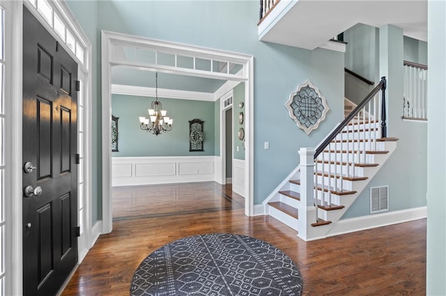 foyer with a notable chandelier and dark hardwood / wood-style floors