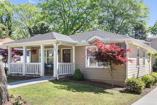 bungalow-style house featuring a porch and a front lawn