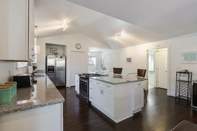 kitchen featuring light stone countertops, stainless steel appliances, white cabinetry, and dark hardwood / wood-style floors