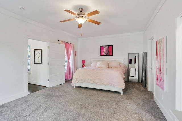 carpeted bedroom with ornamental molding and ceiling fan