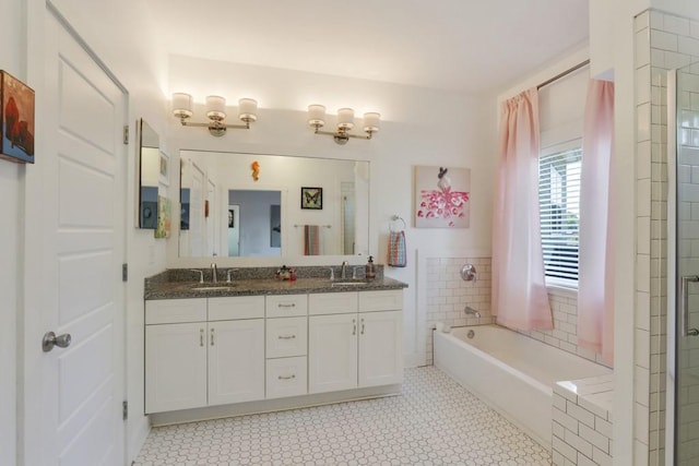 bathroom with a bath, dual bowl vanity, and tile flooring