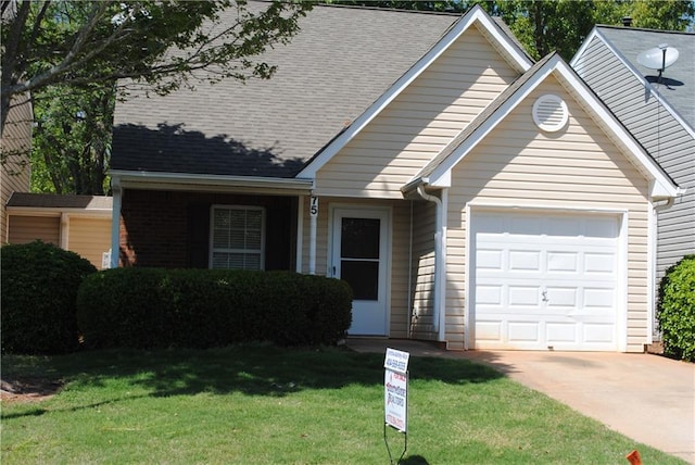 view of front of home featuring a front lawn and a garage