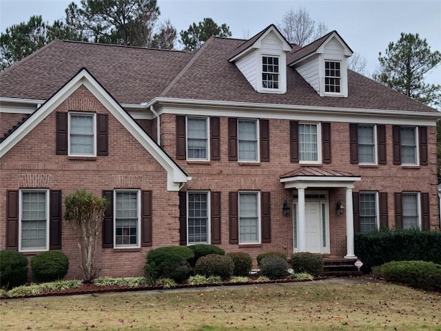 colonial-style house with a front yard