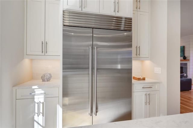 1068 Amsterdam Avenue Ne, Atlanta, GA 30306 - kitchen with backsplash, built in fridge, hardwood / wood-style flooring, and white cabinetry