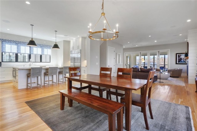 1068 Amsterdam Avenue Ne, Atlanta, GA 30306 - dining area with a notable chandelier, light hardwood / wood-style flooring, sink, and french doors