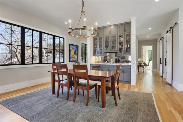 1068 Amsterdam Avenue Ne, Atlanta, GA 30306 - dining space featuring a barn door, light hardwood / wood-style flooring, and a healthy amount of sunlight