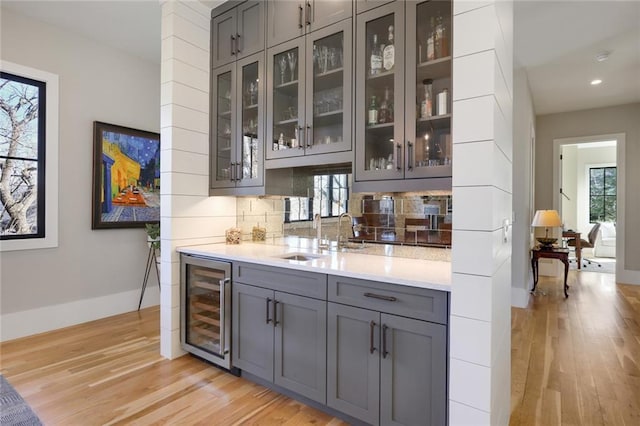 1068 Amsterdam Avenue Ne, Atlanta, GA 30306 - bar featuring gray cabinetry, backsplash, light hardwood / wood-style floors, wine cooler, and sink