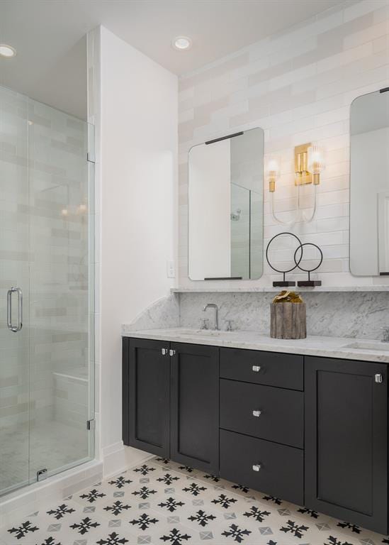 bathroom with tile flooring, tile walls, tasteful backsplash, vanity, and an enclosed shower