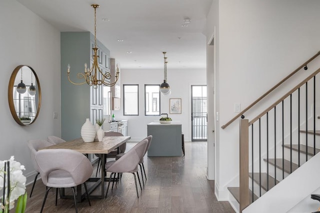 dining area featuring dark wood-type flooring and a chandelier