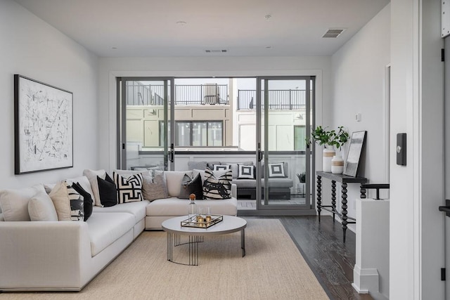 living room with a wealth of natural light and hardwood / wood-style floors