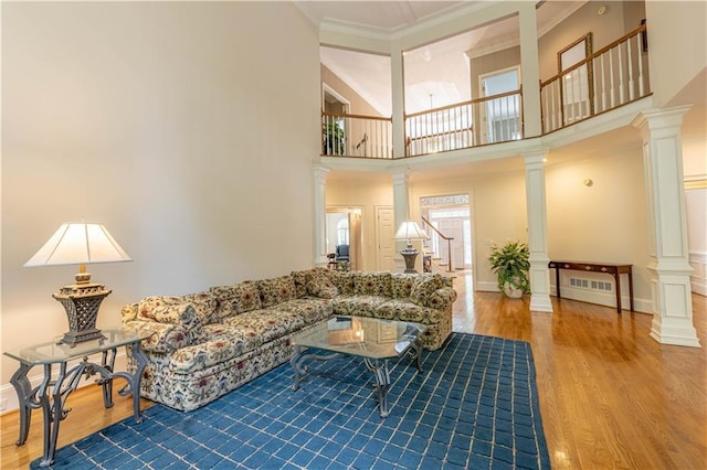 54 Old Fuller Mill Road Ne, Marietta, GA 30067 - living room with a towering ceiling, crown molding, hardwood / wood-style floors, decorative columns, and radiator heating unit
