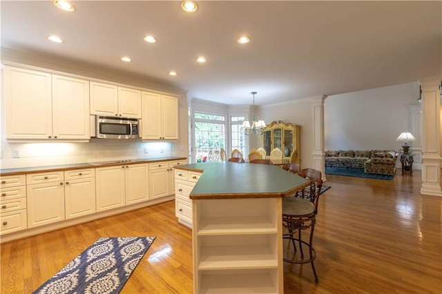 54 Old Fuller Mill Road Ne, Marietta, GA 30067 - kitchen featuring a kitchen island, hanging light fixtures, white cabinets, a chandelier, and light hardwood / wood-style floors