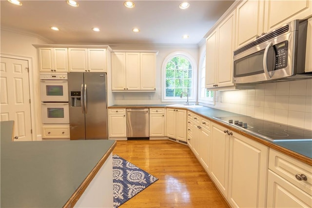 54 Old Fuller Mill Road Ne, Marietta, GA 30067 - kitchen featuring crown molding, appliances with stainless steel finishes, light wood-type flooring, and white cabinetry